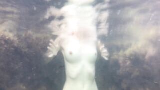 Naked girl swims in the sea and masturbate underwater