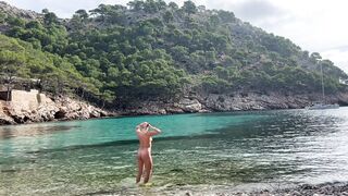 girl swimming on a public beach completely naked