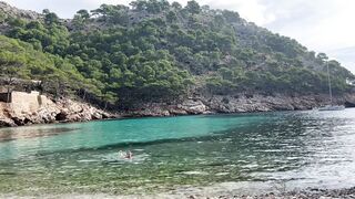 girl swimming on a public beach completely naked