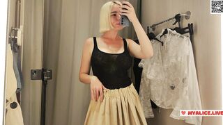 Trying on transparent clothes in the fitting room. Naked blonde flashed her boobs in a public place