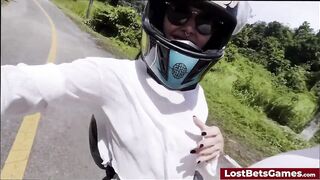 Riding on the motorbike and flashing her sexy body to the camera